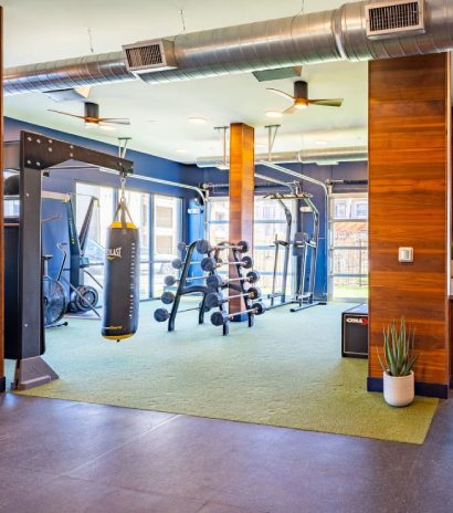 On-site fitness center with cardio equipment, free weights, and punching bags.